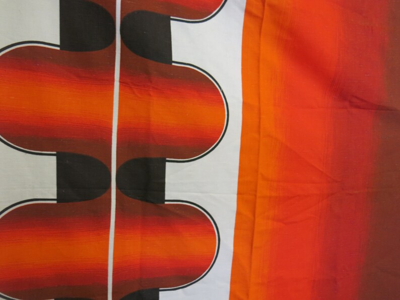 May include: Abstract pattern fabric with a white background and a repeating design of orange and black curved shapes. The fabric has a gradient of orange and red on the right side.