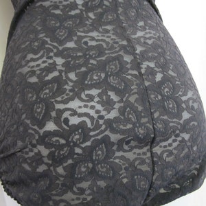 May include: Black lace bodysuit with a floral pattern.