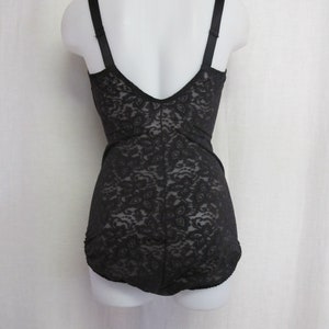 May include: Black lace body suit with adjustable straps. The suit has a low back and a smooth, seamless finish.