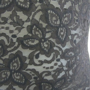 May include: Black lace fabric with a floral pattern.