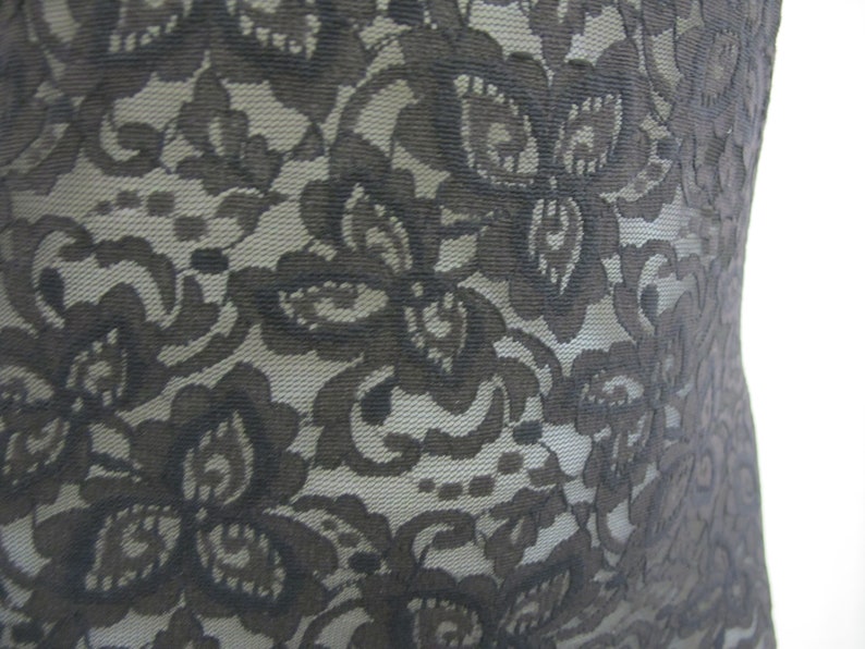 May include: Black lace fabric with a floral pattern.