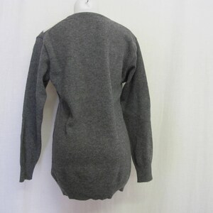 May include: A long-sleeved gray sweater with a crew neck.