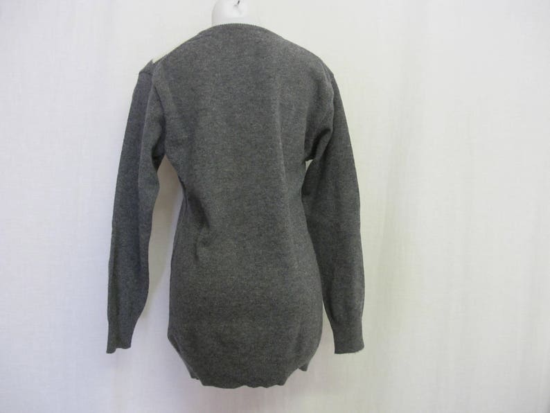 May include: A long-sleeved gray sweater with a crew neck.
