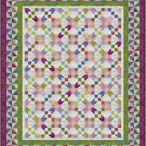 May include: A quilt with a patchwork design featuring a variety of colors and patterns, including pink, green, blue, and white. The quilt is framed with a border of green and purple.