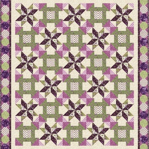 May include: A quilt with a repeating pattern of purple and green stars on a cream background. The quilt is bordered with a purple and green floral pattern.