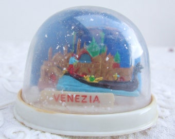 1980s Vintage Italy touristic snow globes: Venezia, Venice. Boat goes to and fro on a binary. Plastic tourism souvenir