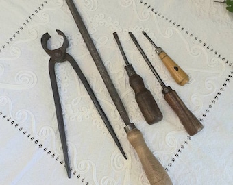 Set of 5 iron manual tools. Woodworking hand utensils. Carpenter woodworker primitive tools with wooden handle. Rasp, pincer, 3 screwdrivers