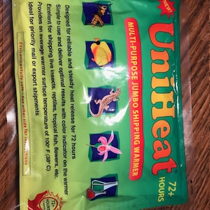 May include: Green and yellow packaging for a UniHeat 72+ Hours Multi-Purpose Jumbo Shipping Warmer. The packaging features a color indicator and images of insects, fish, reptiles, and flowers. The text on the packaging reads "Designed for reliable and steady heat release for 72 hours."