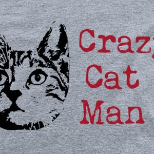 May include: A black and white illustration of a cat's face with the text "Crazy Cat Man" in red.