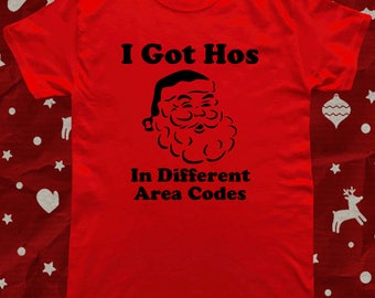 May include: Red t-shirt with a black graphic of Santa Claus and the text "I Got Hos In Different Area Codes".