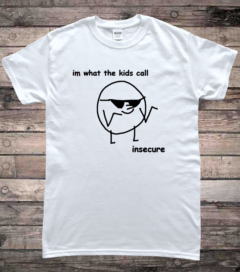 May include: White t-shirt with a black and white illustration of a circle with sunglasses and the text "im what the kids call insecure".