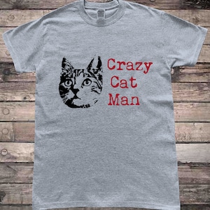May include: Gray t-shirt with a black cat illustration and the text "Crazy Cat Man" in red.