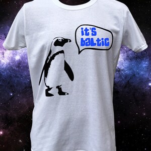 May include: White t-shirt with a black penguin graphic and a speech bubble that says "it's baltic".