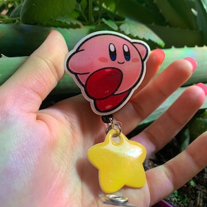 Super cute pink blob named Kirby badge reel great for any job that has I’d cards! Hospitals housekeeping