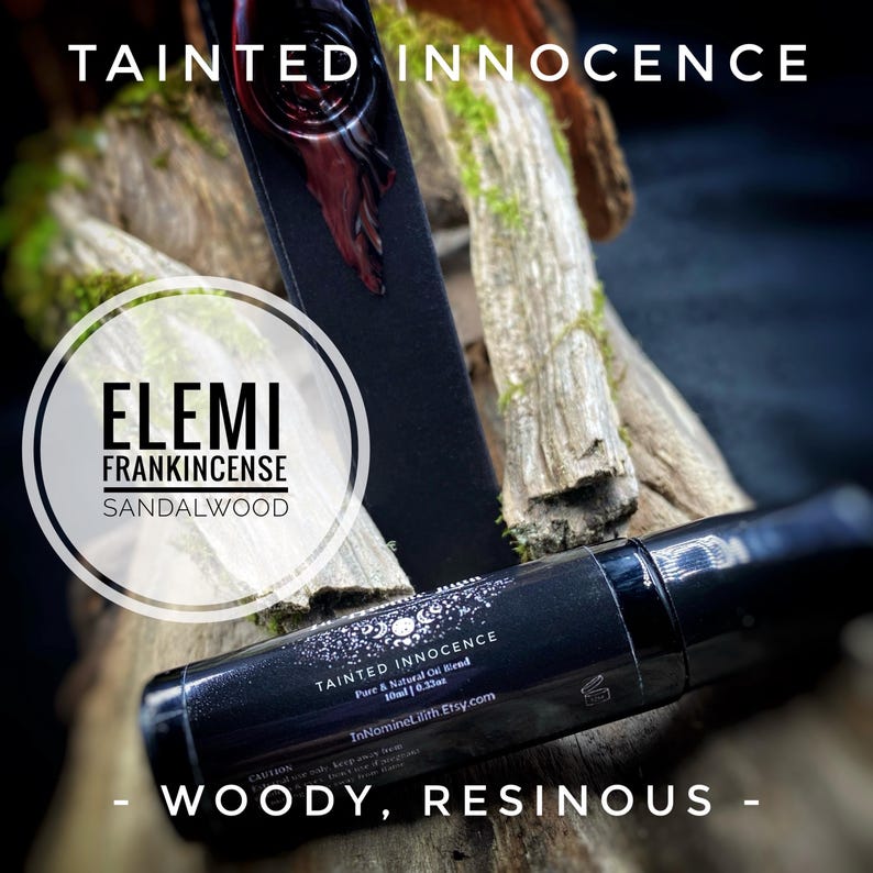 May include: A black essential oil roller bottle with the text "TAINTED INNOCENCE" and "ELEMI FRANKINCENSE SANDALWOOD." The bottle is 10ml / 0.33oz. The background features wood and moss, with the words "WOODY, RESINOUS."