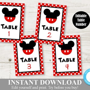 May include: Four table number cards with a red and white polka dot border. Each card features a black Mickey Mouse head silhouette, the word "TABLE" in black, and a red number. The cards are numbered 1, 2, 3, and 4.
