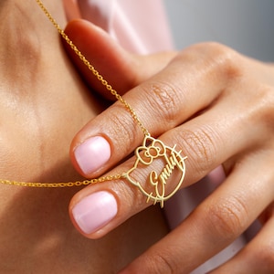 May include: Gold necklace with a Hello Kitty charm featuring the name "Emily" in cursive.