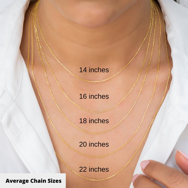 May include: A close-up of a woman's neck wearing five gold chains of different lengths. The chains are labeled with their lengths in inches: 14 inches, 16 inches, 18 inches, 20 inches, and 22 inches. The text "Average Chain Sizes" is at the bottom of the image.