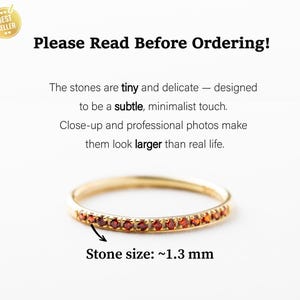 May include: A gold ring featuring a row of tiny red stones, each measuring approximately 1.3 mm. The text reads: Please Read Before Ordering! The stones are tiny and delicate &mdash; designed to be a subtle, minimalist touch. Close-up and professional photos make them look larger than real life. Stone size: ~1.3 mm.