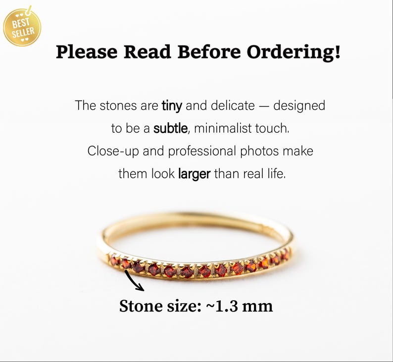 May include: A gold ring featuring a row of tiny red stones, each measuring approximately 1.3 mm. The text reads: Please Read Before Ordering! The stones are tiny and delicate &mdash; designed to be a subtle, minimalist touch. Close-up and professional photos make them look larger than real life. Stone size: ~1.3 mm.