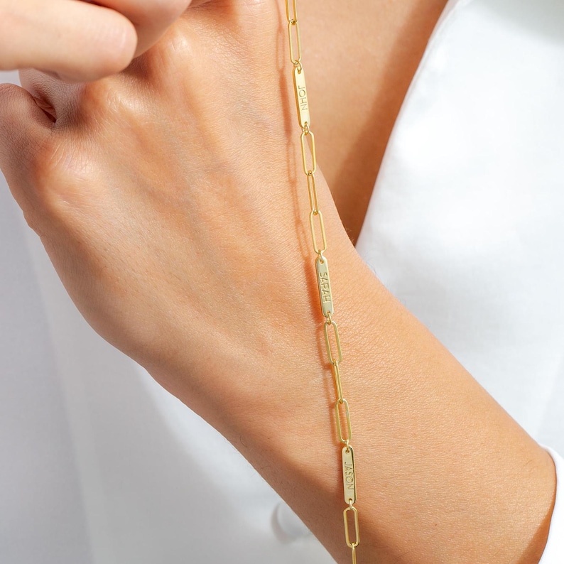 May include: Gold chain necklace with four rectangular name tags. The name tags are engraved with the names "Jason", "Sarah", "Josh", and "Noah".
