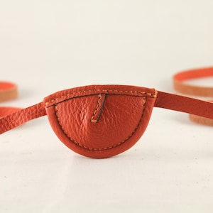 Slim, orange, convex - leather eye patch