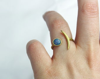 Crescent brass ring with blue opal stone