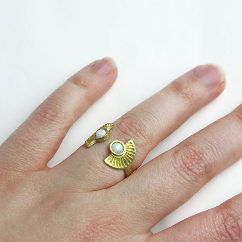 Ornament brass ring with small white opal stones