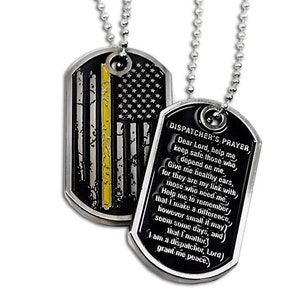 May include: Two silver dog tags on a silver chain. One tag features a black and white American flag with a yellow stripe, the other tag has a black background with the text "DISPATCHER'S PRAYER" and a prayer for dispatchers.