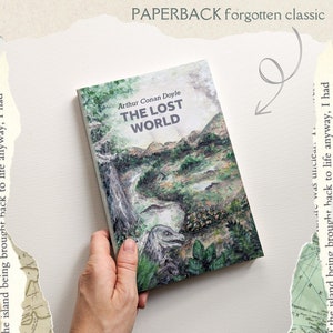 May include: A paperback book cover with a green, brown, and white illustration of a lush jungle with a dinosaur. The title of the book is "The Lost World" by Arthur Conan Doyle. The book is labeled as a "PAPERBACK forgotten classic".