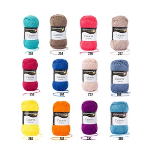 May include: A collection of 10 balls of Schachenmayr Catania Originals yarn in various colours, including teal, brown, red, pink, blue, yellow, orange, purple, and light blue. Each ball is labelled with the Schachenmayr logo and the yarn name.