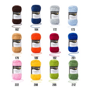 May include: Assortment of 10 balls of Catania yarn in various colours, including brown, blue, light blue, orange, red, dark blue, pink, yellow, green, and olive green. Each ball has a label with the brand name "Schachenmayr" and the yarn name "Catania".