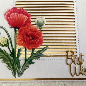 May include: A greeting card featuring red poppy flowers and green leaves. The background has gold horizontal stripes and the words "Best Wishes" in gold script. The card has a gold border.
