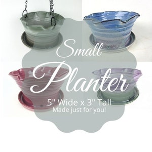 May include: Four small ceramic planters in shades of green, blue, burgundy, and lavender. Each planter has a wavy rim and sits on a matching saucer. The text reads "Small Planter" and "5" Wide x 3" Tall". One planter is hanging from a chain.