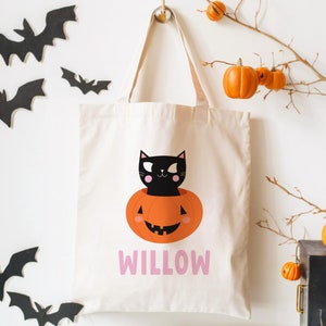 halloween candy tote bag for kids customized with name and a cute black cat in a pumpkin