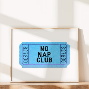 May include: A framed print of a blue ticket with the text "NO NAP CLUB" and the numbers "827830" on either side.