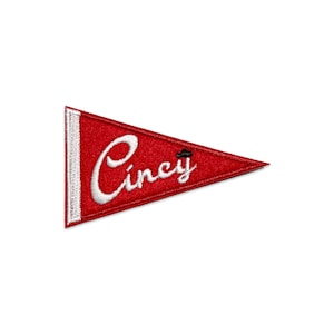 May include: Red felt pennant with white embroidered text that reads "Cincy".