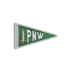 May include: Green felt pennant with white stitching and a white outline. The pennant features a stylised evergreen tree and the text "PNW" in white.