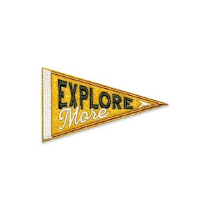 May include: Yellow felt pennant with green and white embroidery that reads "Explore More".
