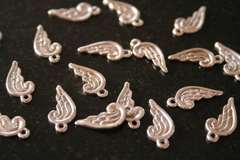 40 wing in antique silver charms. ref:2432 .