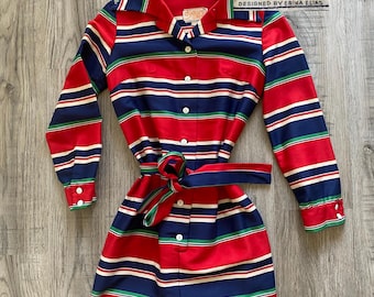 May include: A vintage red, white, blue, and green striped dress with long sleeves and a matching belt. The dress has a collared neckline and button-down front. The tag reads "Charlie's Girls, Designed by Erika Elias."