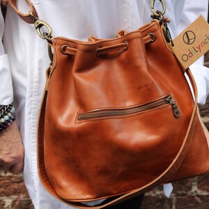 Bucket bag tan leather, Front zip pocket, Shoulder or chest strap, Cross body strap, Inner compartments, Soft leather, Drawstring top purse image 4