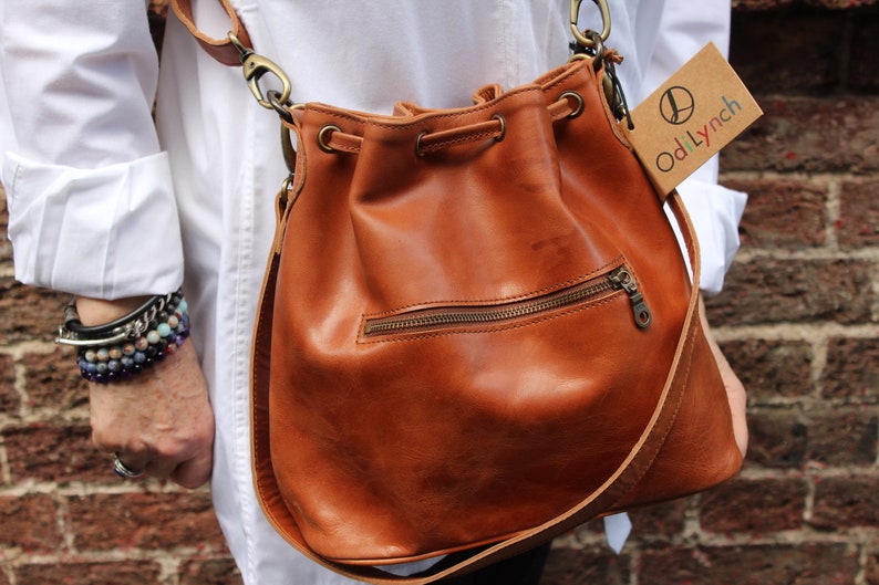 Bucket bag tan leather, Front zip pocket, Shoulder or chest strap, Cross body strap, Inner compartments, Soft leather, Drawstring top purse image 4