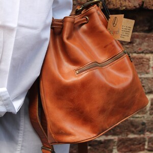 Bucket bag tan leather, Front zip pocket, Shoulder or chest strap, Cross body strap, Inner compartments, Soft leather, Drawstring top purse image 3