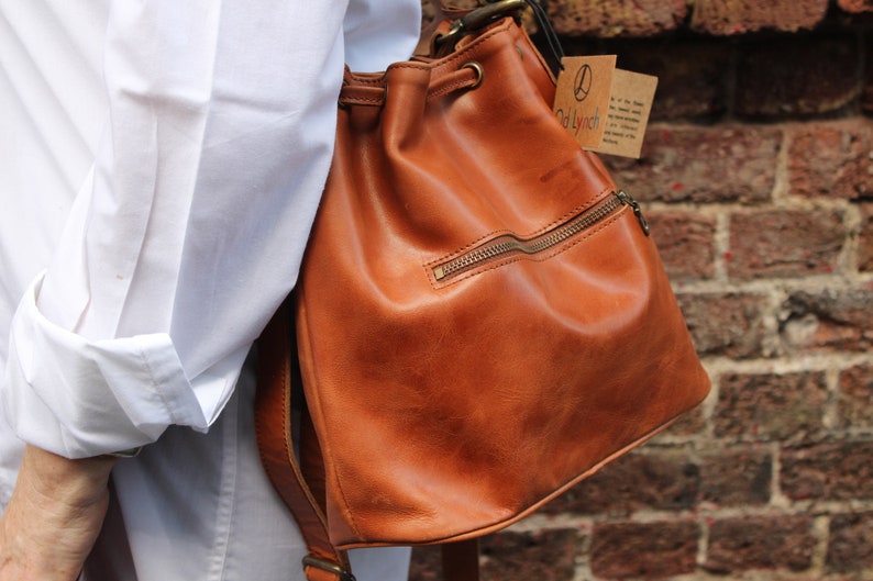 Bucket bag tan leather, Front zip pocket, Shoulder or chest strap, Cross body strap, Inner compartments, Soft leather, Drawstring top purse image 3