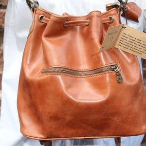 Bucket bag tan leather, Front zip pocket, Shoulder or chest strap, Cross body strap, Inner compartments, Soft leather, Drawstring top purse image 1