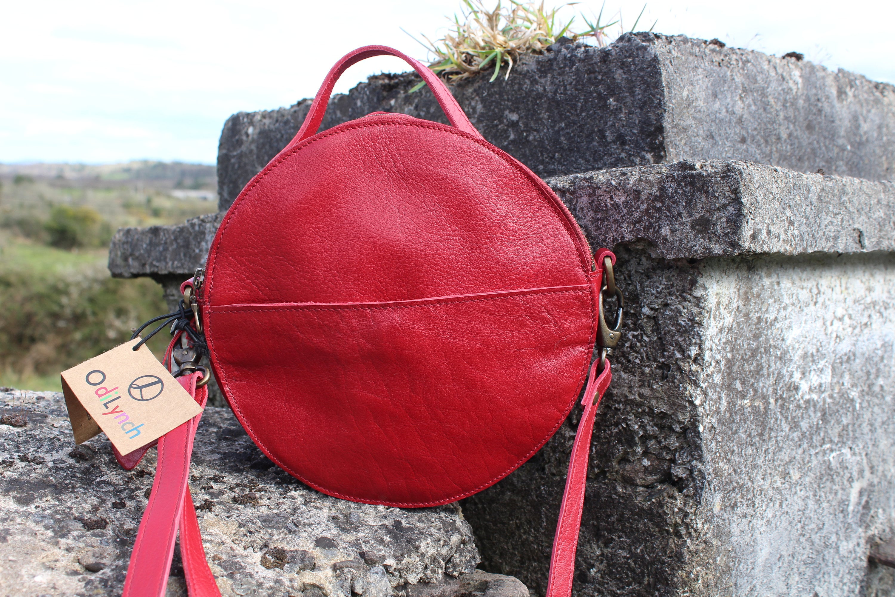 Circular Leather Bag, Round Bag, Red Leather, Cross Body Handbag, Long Strap Adjustable, Front Pocket, Internal Zip and Flap Pocket, Rupert Circular Leather Bag, Round Bag, Red Leather, Cross Body Handbag, Long Strap Adjustable, Front Pocket, Internal Zip and Flap Pocket, Rupert