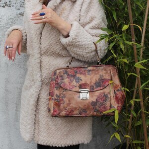 Absolutely stunning rare and unique doctor bag with silver pushlocked front pocket, floral or flowerprinted leather, genuine leather, extra durable lining with both zip and slip pockets, elbow handle and optional long strap a very spacious accessible