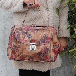 Absolutely stunning rare and unique doctor bag with silver push-locked front pocket, floral or flower-printed leather, genuine leather, extra durable lining with both zip and slip pockets, elbow handle and optional long strap very spacious accessible