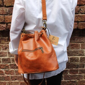 Bucket bag tan leather, Front zip pocket, Shoulder or chest strap, Cross body strap, Inner compartments, Soft leather, Drawstring top purse image 6